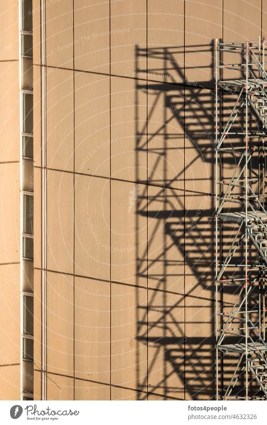 Gerüst am Hochhaus Schatten grafisch Muster Quadrate Linien Treppen Höhe braun Fenster abstrakt Strukturen & Formen Fassade minimalistisch Renovieren Wand