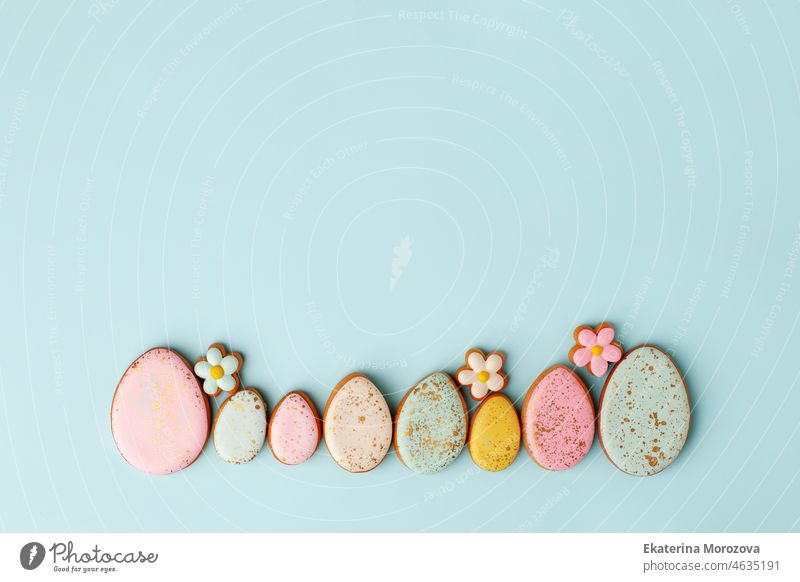 Süßigkeiten, Gebäck, Lebkuchen Cookies für Ostern Tabelle. Ostereier und zarte einfache Blumen auf blauem Hintergrund oben Ansicht Kopie Raum, Frühling saisonalen Urlaub Banner für Ihre sute, Flyer, Coupon