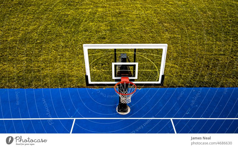 Blaues Basketballfeld mit klarem Korb und grasbewachsenem Hintergrund Gras Herbst sonnig Farbe keine Menschen Natur Ball Land Sommer Dröhnen Netz außerhalb