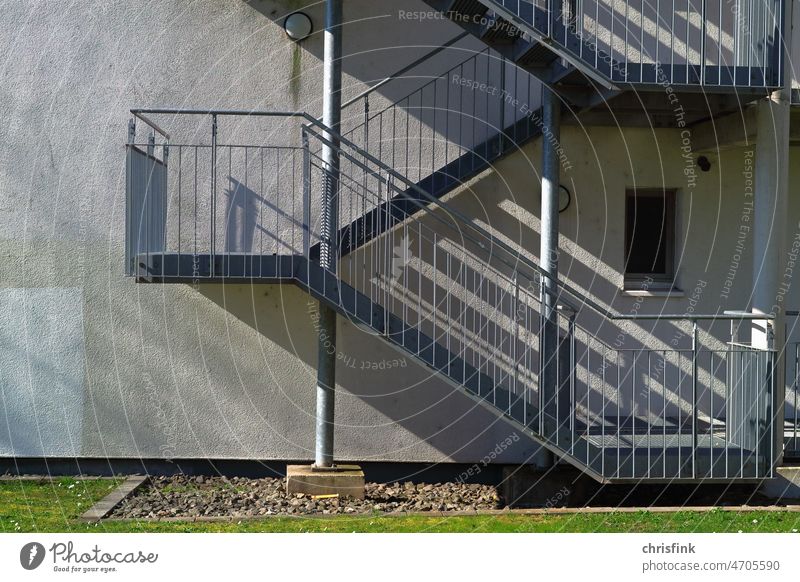 Außentreppe an Wohnhaus mit Schattenwurf Treppe wohnhaus Büro Stufe Leiter treppenabsatz aufwärts abwärts wohnen aufstieg abstieg mehrfamilienhaus mietshaus