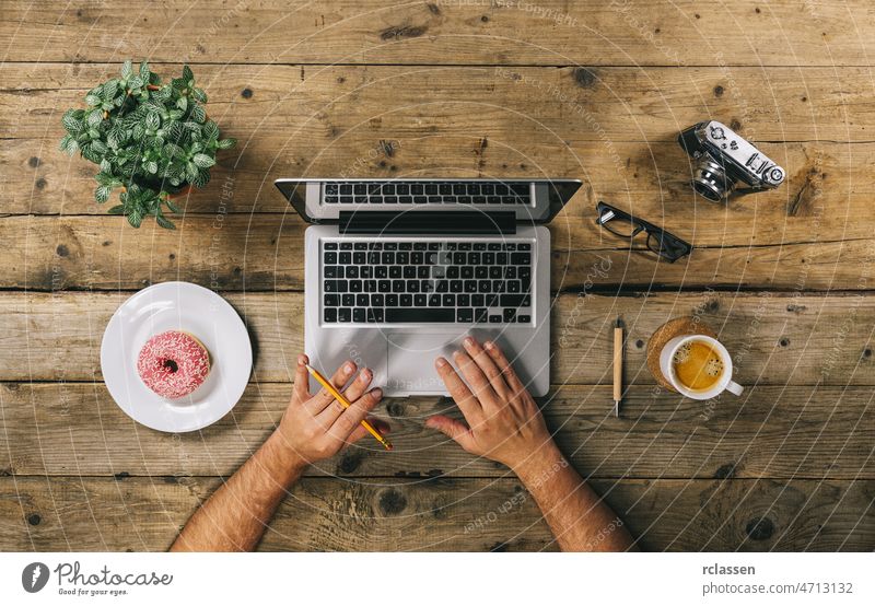 Hipster vintage hölzernen Schreibtisch Draufsicht, männliche Hände tippen auf einem Laptop Top Ansicht Business Mann Notebook benutzend oben Architektur