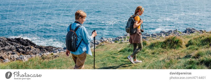 Großmutter und erwachsene Enkelin wandern an der Küste entlang Frauen Trekking Ufer MEER Familie Transparente Netz Kopfball Panorama panoramisch Textfreiraum