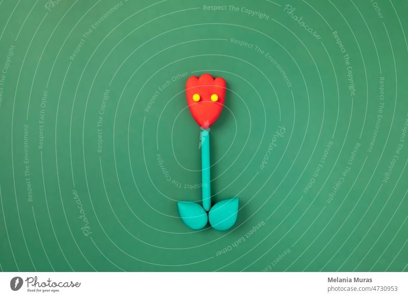 Niedliche rote Tulpenblumenfigur mit Augen auf grüner Wiese. Frühling, Sommerblüte, Grußkarte. abstrakt Hintergrund schön Schönheit Blütezeit Überstrahlung