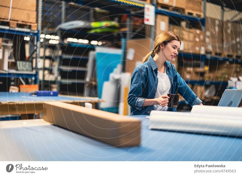 Frau benutzt Laptop im Lagerhaus Business Ladung selbstbewusst liefernd Versand Verteilung Mitarbeiter Fabrik Ware industriell Industrie Job