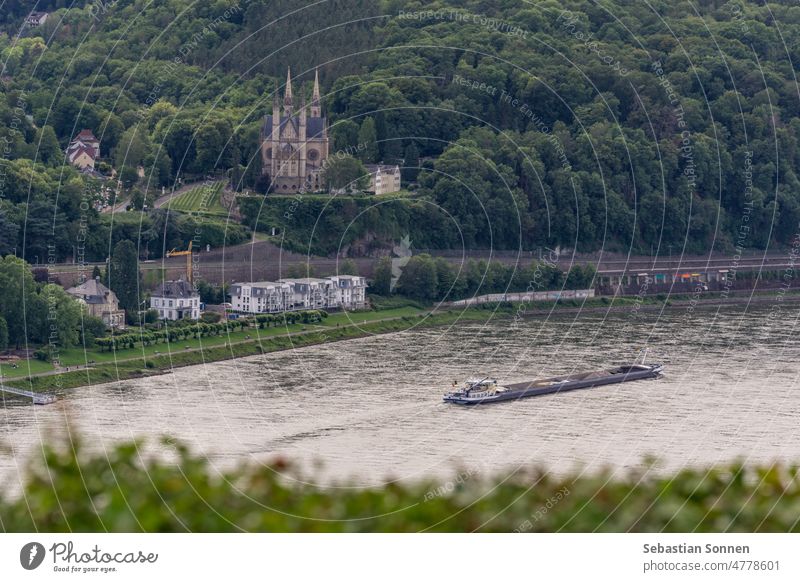 Luftaufnahme der Kirche St. Apollinaris, umgeben von Wald, vor dem Rhein mit Boot, Remagen, Deutschland Rheintal Apollinariskirche Kultur Europa Bonn