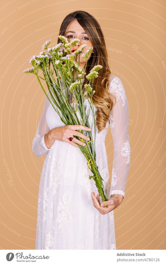 Braut im Kleid an Blumen riechend Frau weißes Kleid Hochzeit Stil Anlass Blumenstrauß geblümt Veranstaltung elegant Pflanze präsentieren duftig Aroma Feiertag