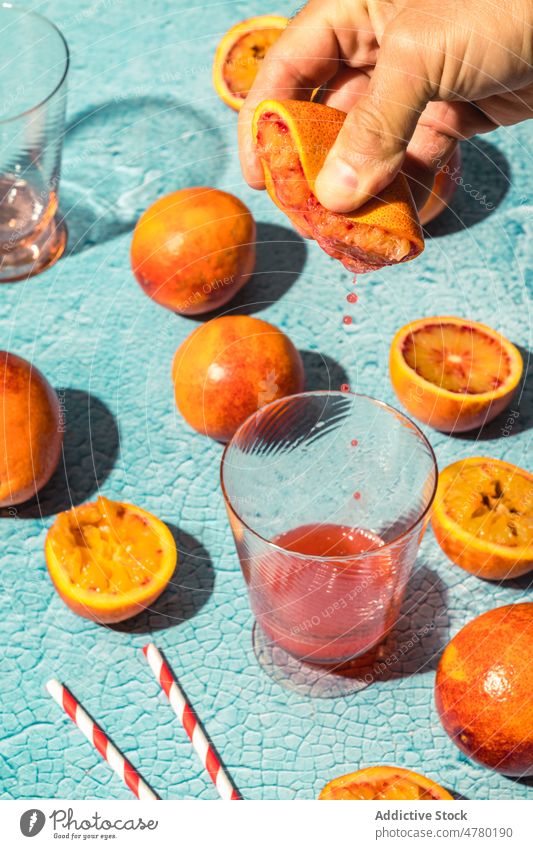 Unbekannte Person beim Auspressen einer Blutorange drücken Saft Frucht gesunde Ernährung natürlich Zitrusfrüchte Vitamin organisch Haufen Geschmack frisch Raum