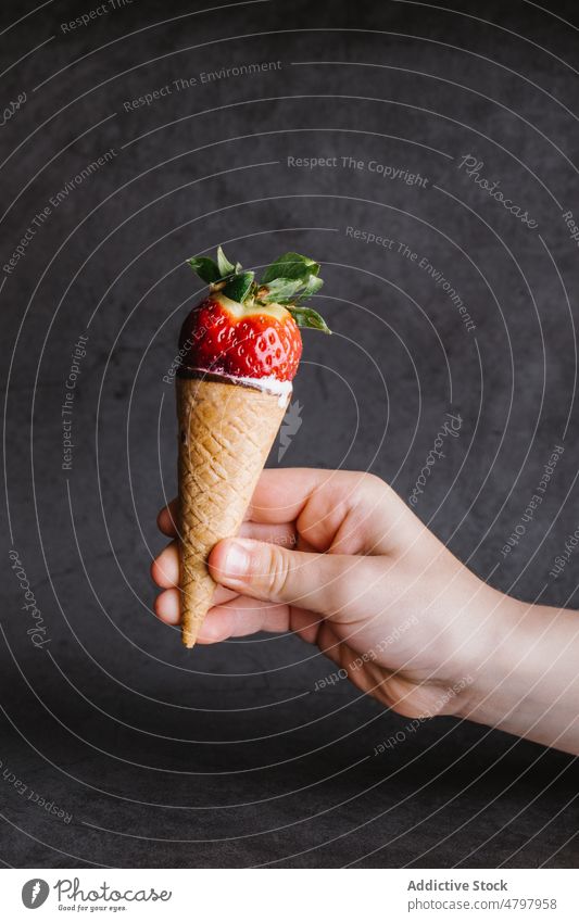 Anonyme Person hält Eiswaffel mit Erdbeere Speiseeis Erdbeeren süß Dessert Zapfen Leckerbissen schwelgen Geschmack Produkt Beeren lecker Hand Lebensmittel kalt