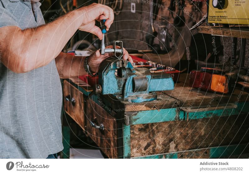 Crop reifen Mechaniker Reparatur Details an Werkbank in der Garage Mann Detailaufnahme Metall Schraubstock Ratsche Meister Werkstatt Hobelbank männlich