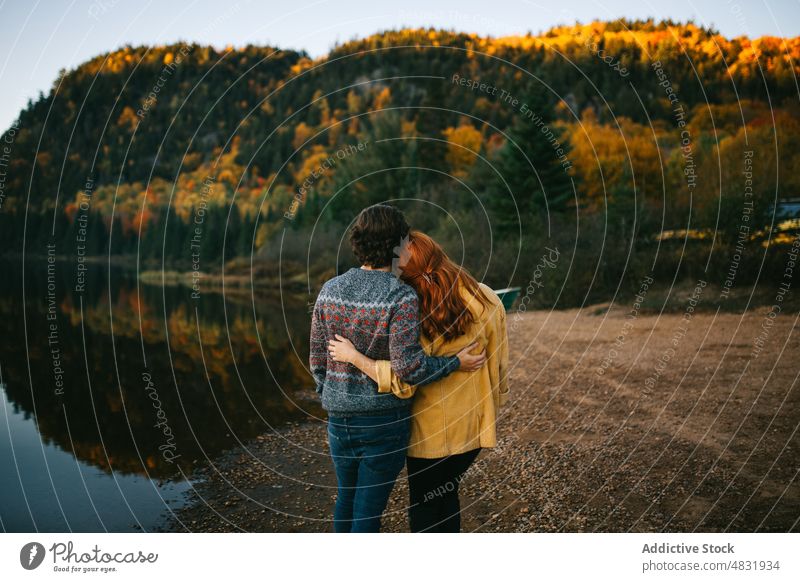 Anonymes Liebespaar kuschelnd am Seeufer an einem Herbsttag Paar Umarmen Wald Ausflug bewundern Umarmung reisen Partnerschaft romantisch Landschaft Natur Freund