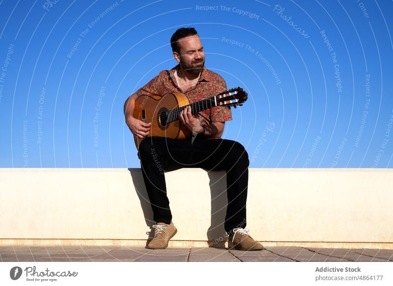 Mann spielt Gitarre auf der Straße Gitarrenspieler spielen Musiker Gesang Instrument Hobby akustisch Großstadt üben Talent männlich Augen geschlossen Fokus