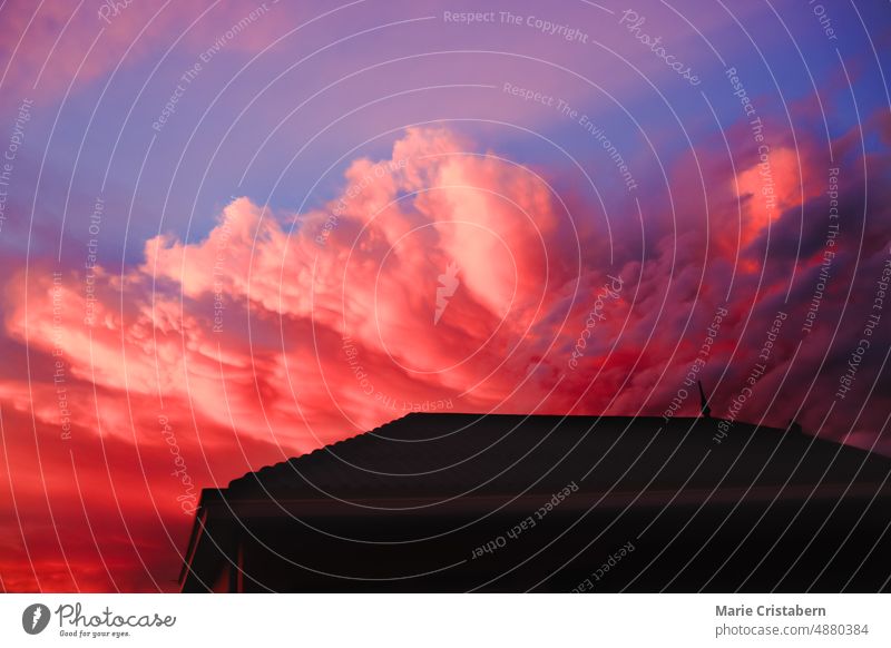 Dramatische Wolke Muster steigt aus hinter einer Silhouette eines Hauses rosa dramatische Wolken Tiefblick farbenfroh Sommer Haussilhouette Abenddämmerung