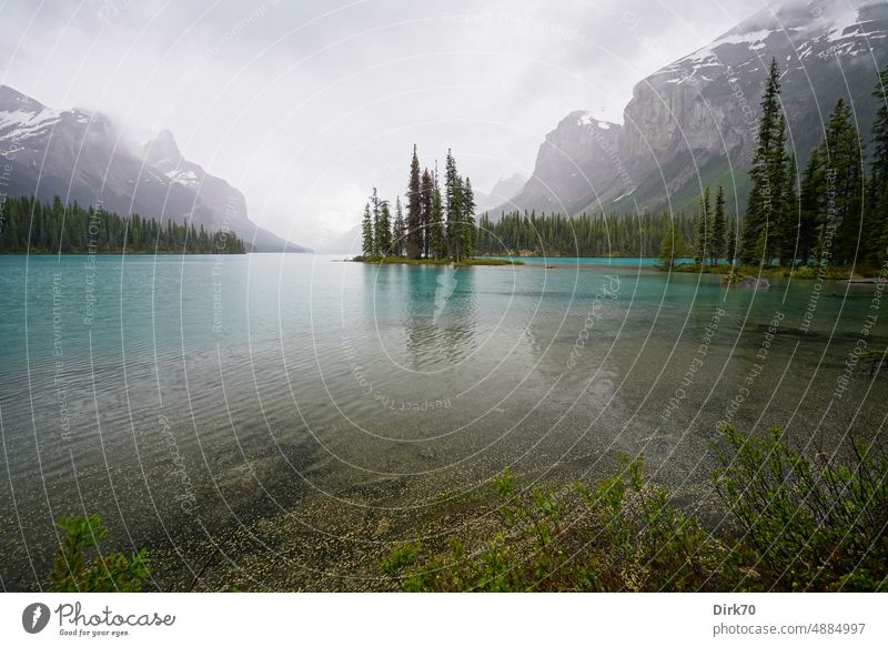 Spirit Island im Maligne Lake, Jasper National Park, Alberta, Kanada, bei grauem Himmel See Seeufer Gletschersee Berge u. Gebirge Wolken grauer Himmel Wald