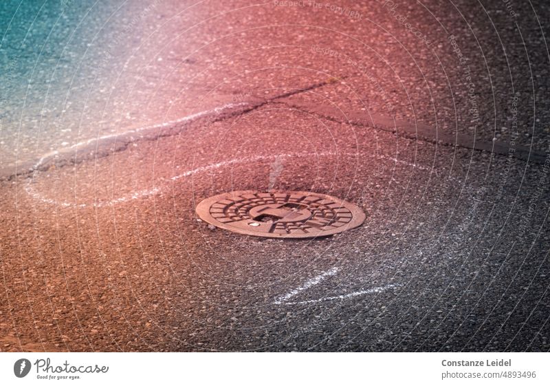 Weißer Kreidestrich mit Pfeilspitze auf farbigem Asphalt mit runder Plakette Linie Schilder & Markierungen Wege & Pfade Verkehrswege Gully Streifen unten