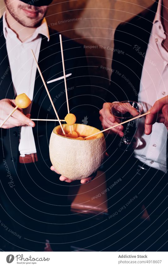 Unbekannte Männer essen Melone im Restaurant Party Snack Frucht Freund Melonen Ball feiern Anlass Lebensmittel festlich Spieß Bonden elegant Freundschaft lecker