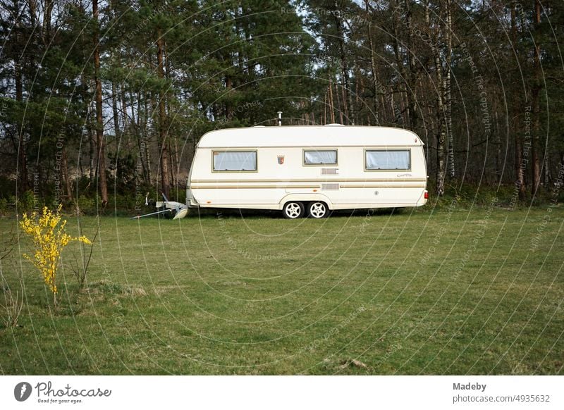 Großer Wohnwagen in Beige und Naturfarben für Camping und Vanlife auf dem Campingplatz im Grünen mit Wald und Wiese am Segelflugplatz in Oerlinghausen bei Bielefeld am Hermannsweg im Teutoburger Wald in Ostwestfalen-Lippe