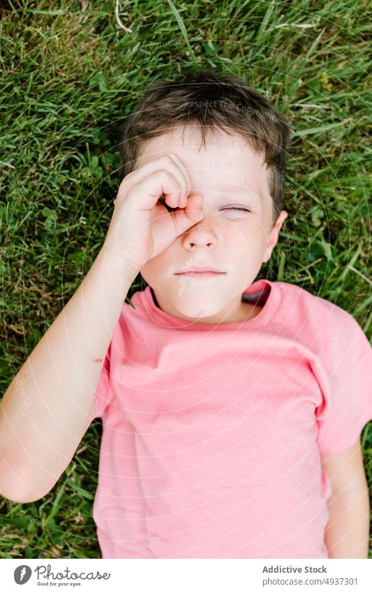 Junge schaut durch die Hand in die Kamera Gras Rasen Park Sommer Fernglas gestikulieren Wochenende lässig Kind Kindheit wenig Zeitvertreib Erholung Saison Feld