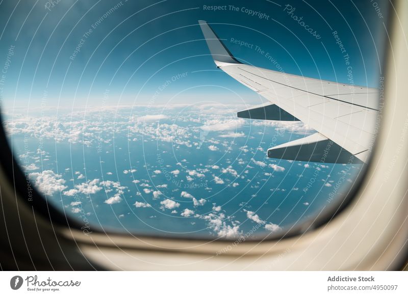 Flugzeugflügel in bewölktem Himmel Flügel Fenster Ebene Blauer Himmel wolkig Ausflug Luftverkehr Fliege reisen Düsenflugzeug Verkehr modern Fluggesellschaft