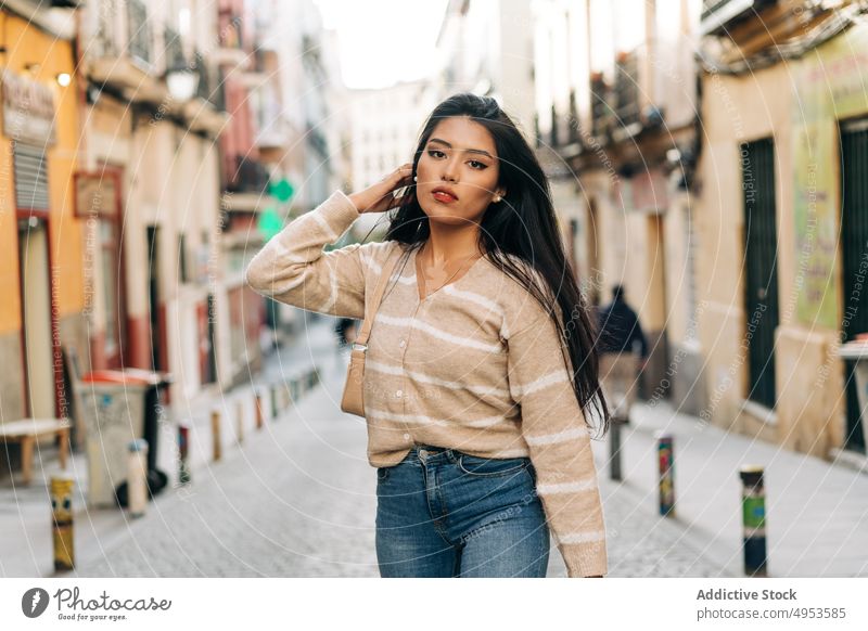 Asiatische Frau in legerer Kleidung auf städtischem Bürgersteig feminin Angebot charmant freundlich angenehm lässig Stil Laufsteg Porträt Handtasche Accessoire