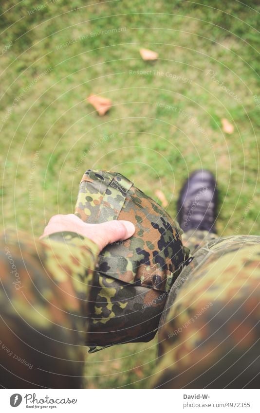 Soldat mit Helm in der Hand Bundeswehr aufrüstung Tarnung Flecktarn Schutz Militär Deutschland verteidigung grün Mann wehrpflicht