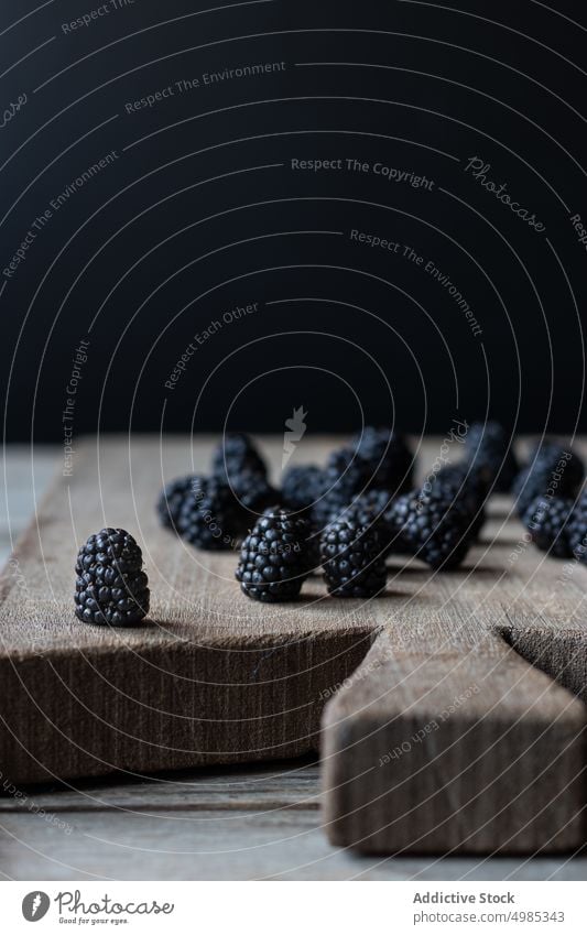 Blaubeeren auf ein Schneidebrett aus Holz legen Holzplatte hölzern Schneiden zerkleinernd frisch reif Beeren Lebensmittel lecker Gesundheit süß Sommer natürlich