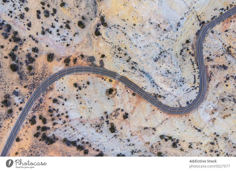 Drohnenansicht einer asphaltierten Straße, die durch ein sandiges Tal in Utah führt Autobahn Berge u. Gebirge Landschaft Panoramastraße 12 Fahrbahn Route Natur