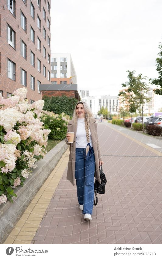 Frau mit Kaffee auf dem Weg zur Arbeit Spaziergang Straße Morgen Arbeitsweg Stil zum Mitnehmen urban Straßenbelag Imbissbude Lächeln Glück heiter Optimist