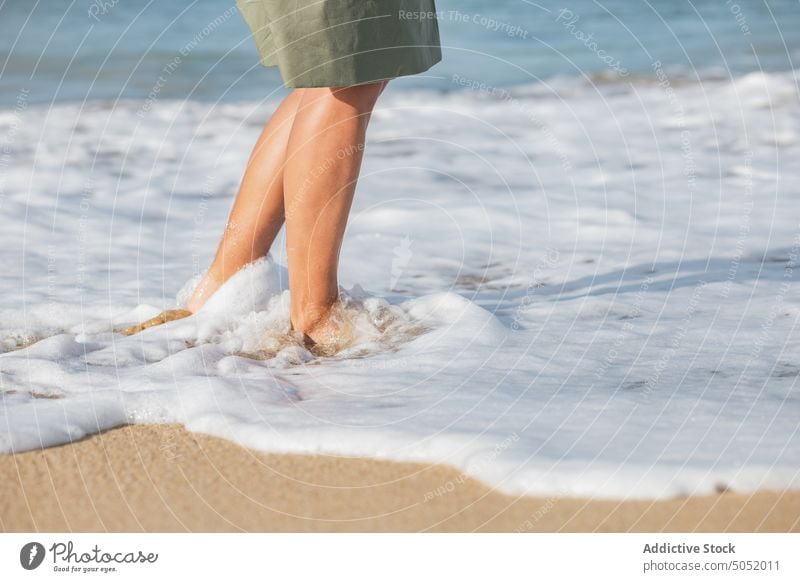 Crop barfuß Frau zu Fuß entlang der Meeresküste Barfuß Spaziergang MEER Wasser winken schäumen Strand Sand Küste Ufer Urlaub Natur reisen Feiertag Meeresufer