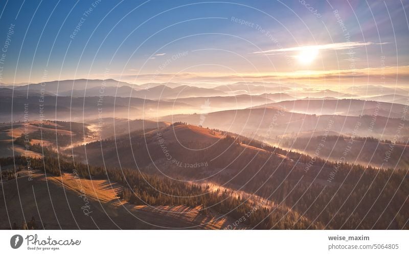 Berg Herbst Sonnenaufgang. Majestätische Morgennebel, Schöne tonale Perspektive. Herbst sonnige Landschaft, nebligen Wald auf Hügeln. Majestätische Luftlandschaft des Tals