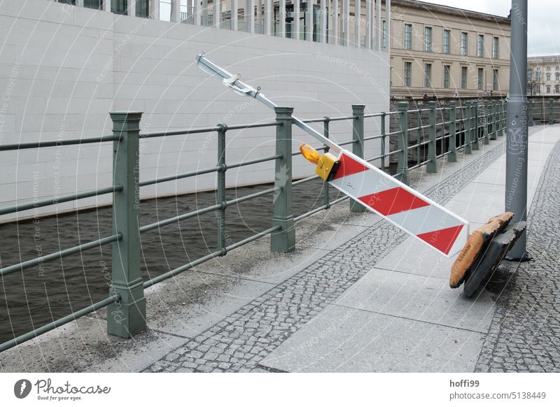 umgekippte schräge Leitbake auf Fußweg und Uferbefestigung Absperrung Sturm rot Sicherheit umgefallen Schutz Schilder & Markierungen Barriere rot-weiß Baustelle