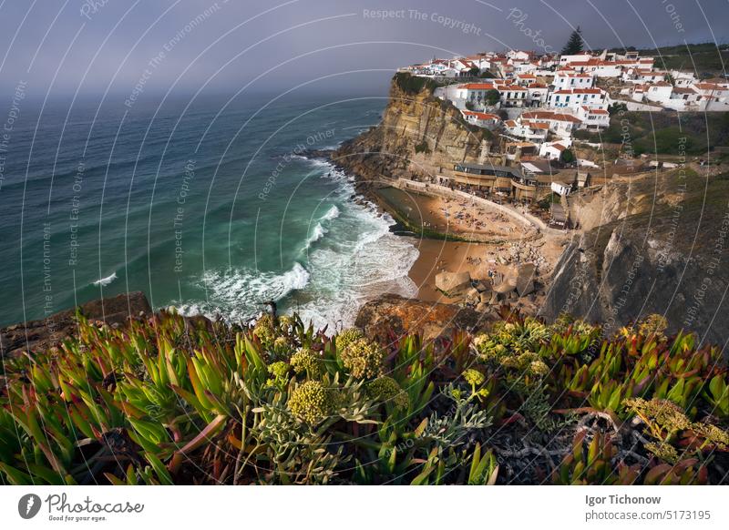 Verträumter Blick auf das malerische Dorf Azenhas do Mar im Licht des Sonnenuntergangs mit Kreidehäusern am Rande einer Klippe und dem Strand darunter. Sintra Wahrzeichen, Portugal, Europa