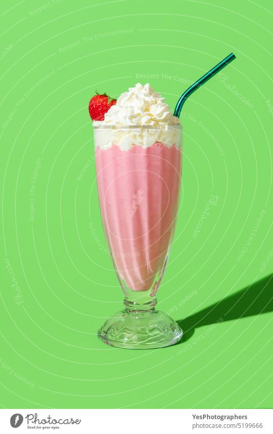 Erdbeermilchshake mit Schlagsahne, minimalistisch auf einem grünen Hintergrund Amerikaner Getränk hell Cocktail kalt Farbe Textfreiraum Sahne Küche Tasse