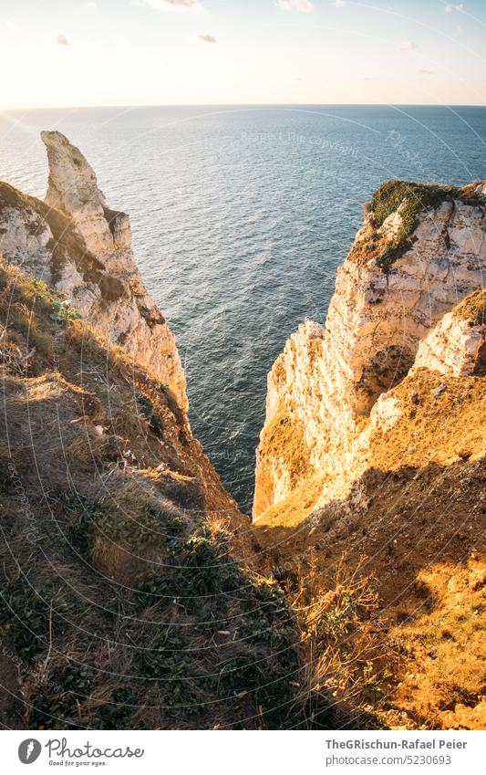 Küste mit Felsen und Meer im Sonnenuntergang Frankreich Normandie Étretat Stimmung Abendstimmung Klippen Landschaft Natur Außenaufnahme Tourismus Sommer