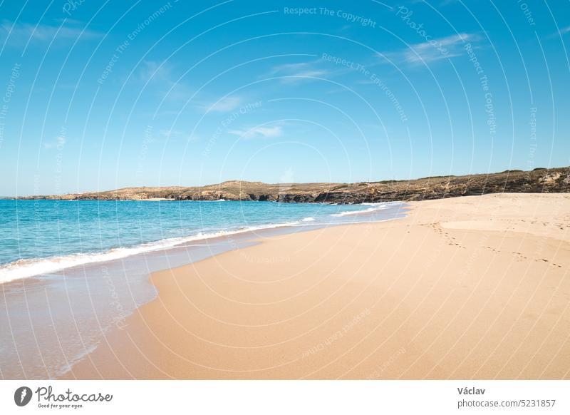 Spaziergang entlang des Atlantiks am Strand Praia da Ilha do Pessegueiro in der Nähe von Porto Covo, Westportugal. Schritte über die Rota Vicentina Sand