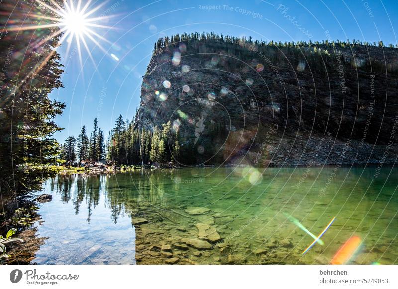 märchenwelt beeindruckend Gletschersee Felsen Steine Gegenlicht Sonnenstern Sonnenlicht Alberta Abenteuer Freiheit See Landschaft Berge u. Gebirge Kanada