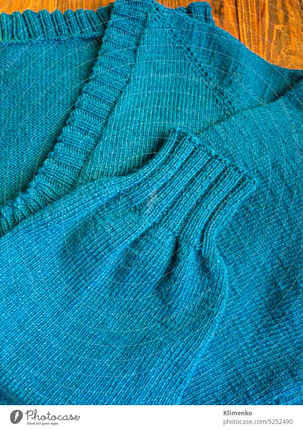 Gestrickte handgefertigte Produkte. Gestrickter Stoff aus farbigen Fäden in der Farbe Petrol. stricken Pullover Schleifen Jacke Krawatte Fussel Nerz Benzin