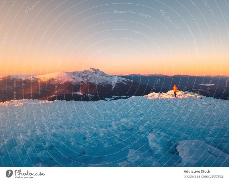 Anonymer Tourist beim Wandern in bergigem Terrain Sonnenuntergang Berge u. Gebirge Schnee Reisender Hügel Natur Landschaft Winter Hochland malerisch Spanien