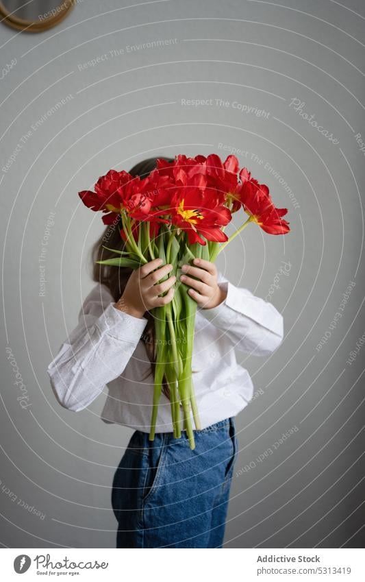 Unbekannte Frau mit einem Strauß Amaryllisblüten stehend Blume Flora Pflanze Blüte Blütezeit Vorbau Konzept geblümt filigran frisch rot Angebot romantisch jung