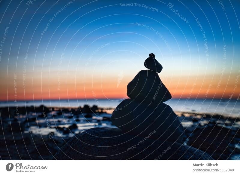 Steinpyramide an der Ostsee mit Blick auf das Meer bei Sonnenuntergang und blauer Stunde Pyramiden MEER baltisch Silhouette Steinhaufen Urlaub Himmel Küste