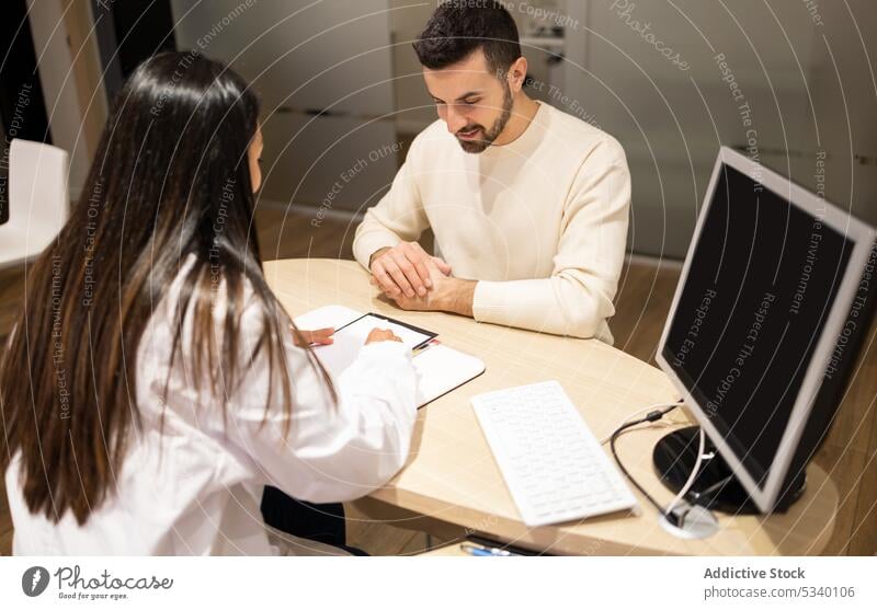 Glückliche Augenärztin bei der Beratung eines männlichen Kunden Mann wählen Brille positiv reden konsultieren optisch Klient Wahl Augenlicht jung Laden Arbeit