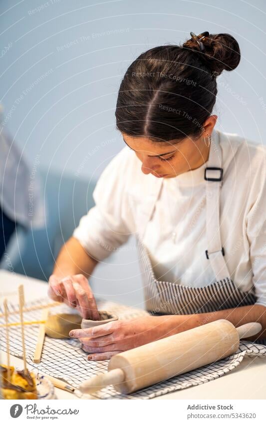 Junge Frau macht Ton am Tisch kreieren Töpferwaren machen handgefertigt Kunstgewerbler Werkstatt Fähigkeit Handwerk Basteln Keramik Vase Hobby kreativ Geschirr