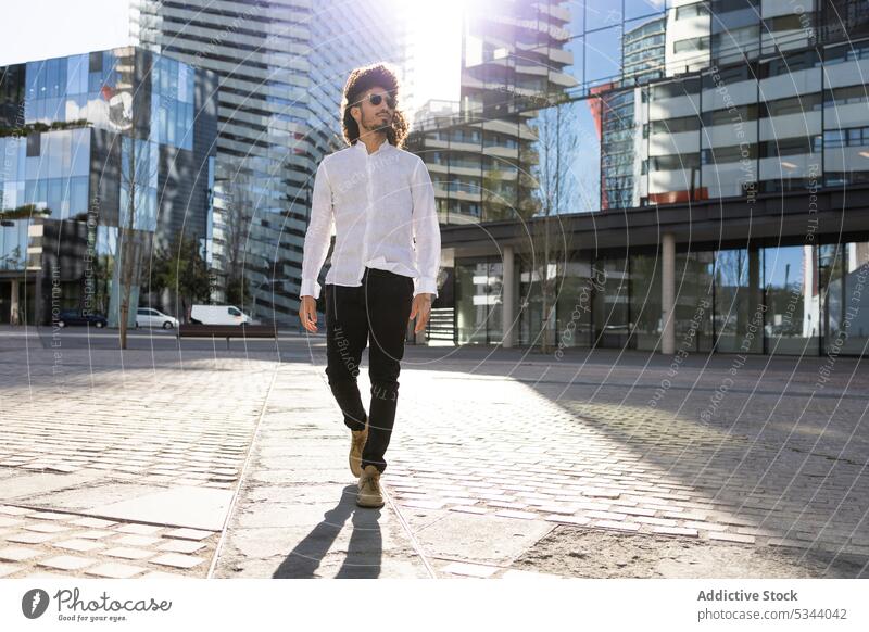 Ethnischer Mann beim Spaziergang in der Stadt Straße selbstbewusst Großstadt besinnlich Afro-Look Apparatur ethnisch männlich Afroamerikaner schwarz modern