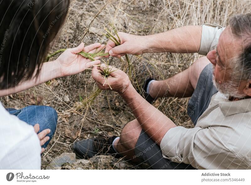 Frau mit Vater hält Halfah-Gras für Naturfaserhandwerk Mann machen handgefertigt esparto Geflecht abholen Landwirt Handwerk Familienunternehmen Ernte Gärtner