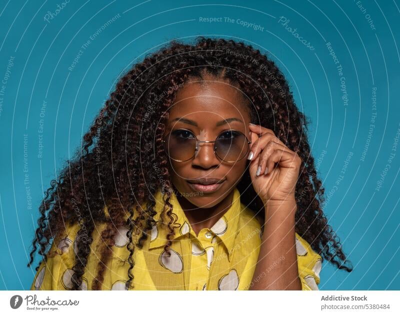 Seriöse stilvolle Frau in trendigem Outfit mit Brille Porträt trendy positiv Mode Frisur Model Stil schwarz Afroamerikaner jung krause Haare Vorschein Dame