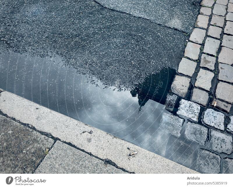 Straßenpfütze, Asphalt, Kopfsteinpflaster und Bordsteinkante Straßenbelag Stein Bürgersteig Wege & Pfade Pflastersteine Pfütze Regen Spiegelung nass