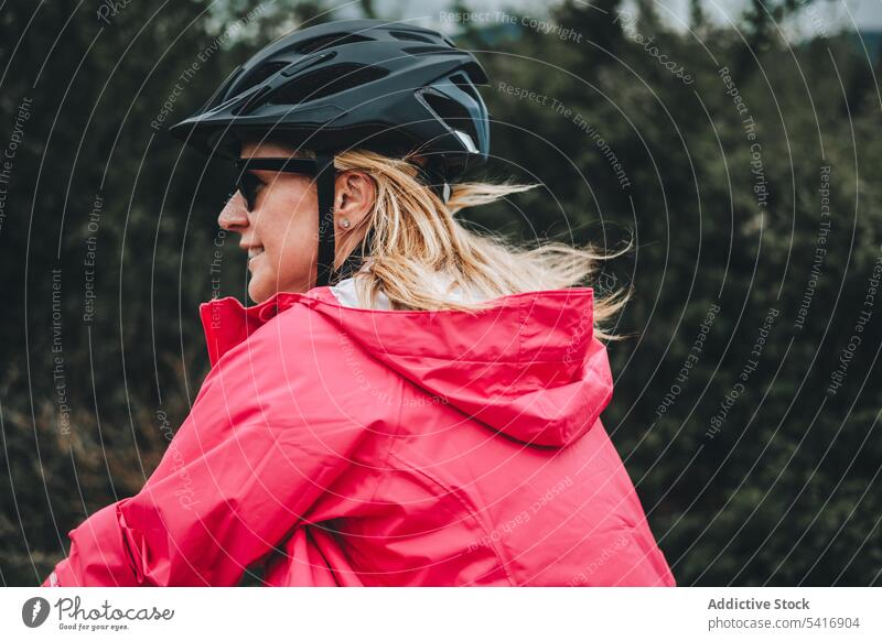 Lächelnde Frau auf dem Fahrrad Reiten Straße jung Person heiter aktiv sportlich Radfahrer genießend Lifestyle reisen Verkehr Abenteuer Schutzhelm Sonnenbrille