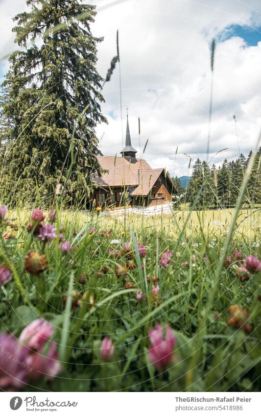 Kirche mit Baum und Gras im Vordergrund wandern Aussicht Berge u. Gebirge Schweiz Natur Landschaft Alpen Außenaufnahme Farbfoto Tourismus Wolken