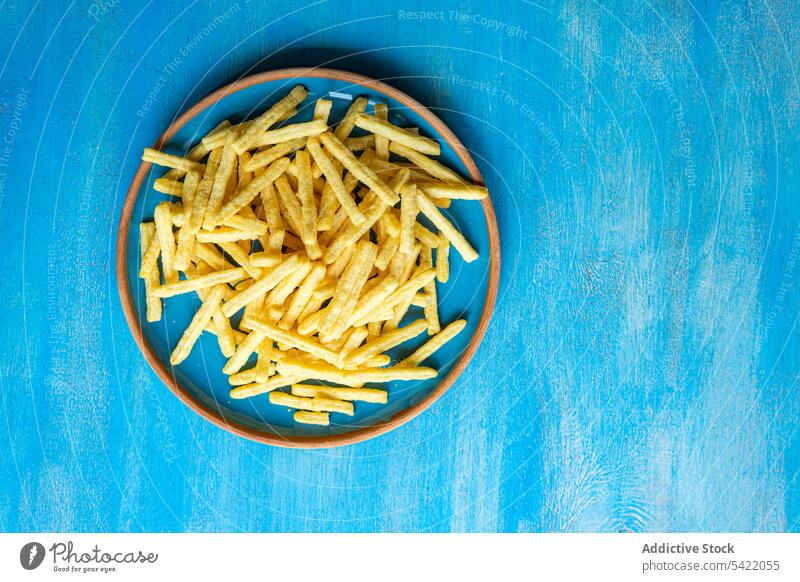 Keramikteller mit Pommes frites Französisch Fries Oberfläche blau hoher Winkel von oben Lebensmittel Abendessen Mahlzeit vorbereitet Speise Küche Rezept lecker