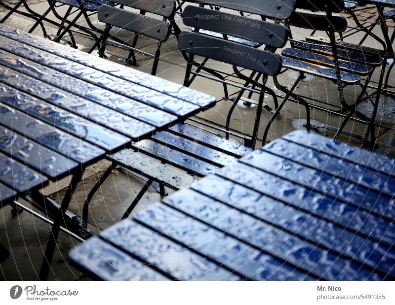 Außengastronomie Regenschauer Regenstimmung Oberfläche Restaurant Gartentisch Wassertropfen schlechtes Wetter Holztisch leer Regenwasser feucht Straßencafé