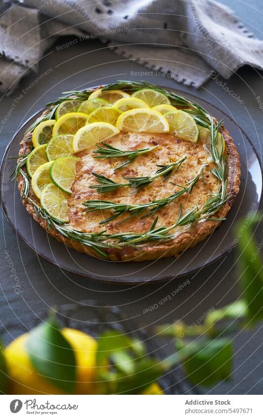 Zitronenkuchen, belegt mit Zitronenscheiben und Rosmarinblättern Pasteten Gebäck selbstgemacht Küche traditionelles Rezept handgefertigt Leckerbissen Herbst